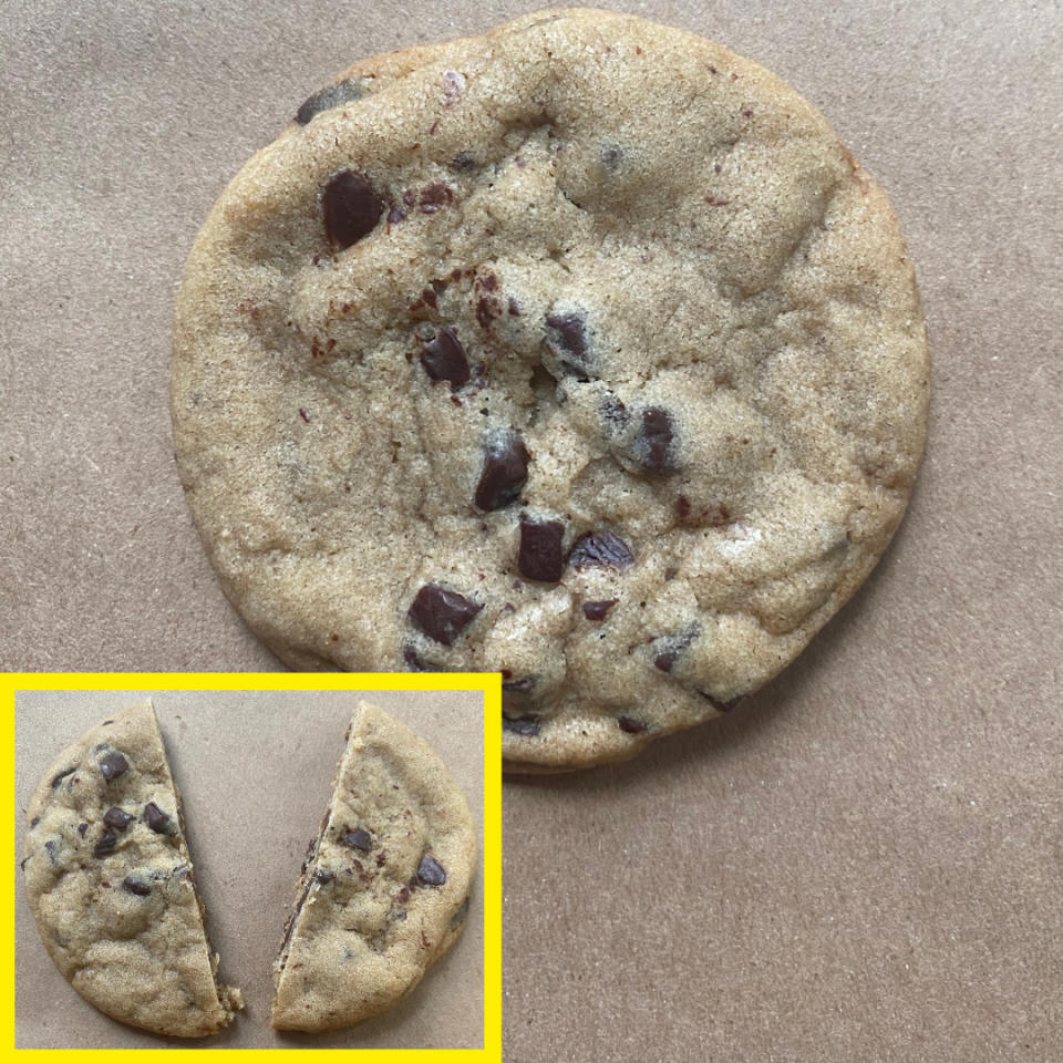 Close-up of a chocolate chip cookie on brown paper with an inset of the same cookie cut in half