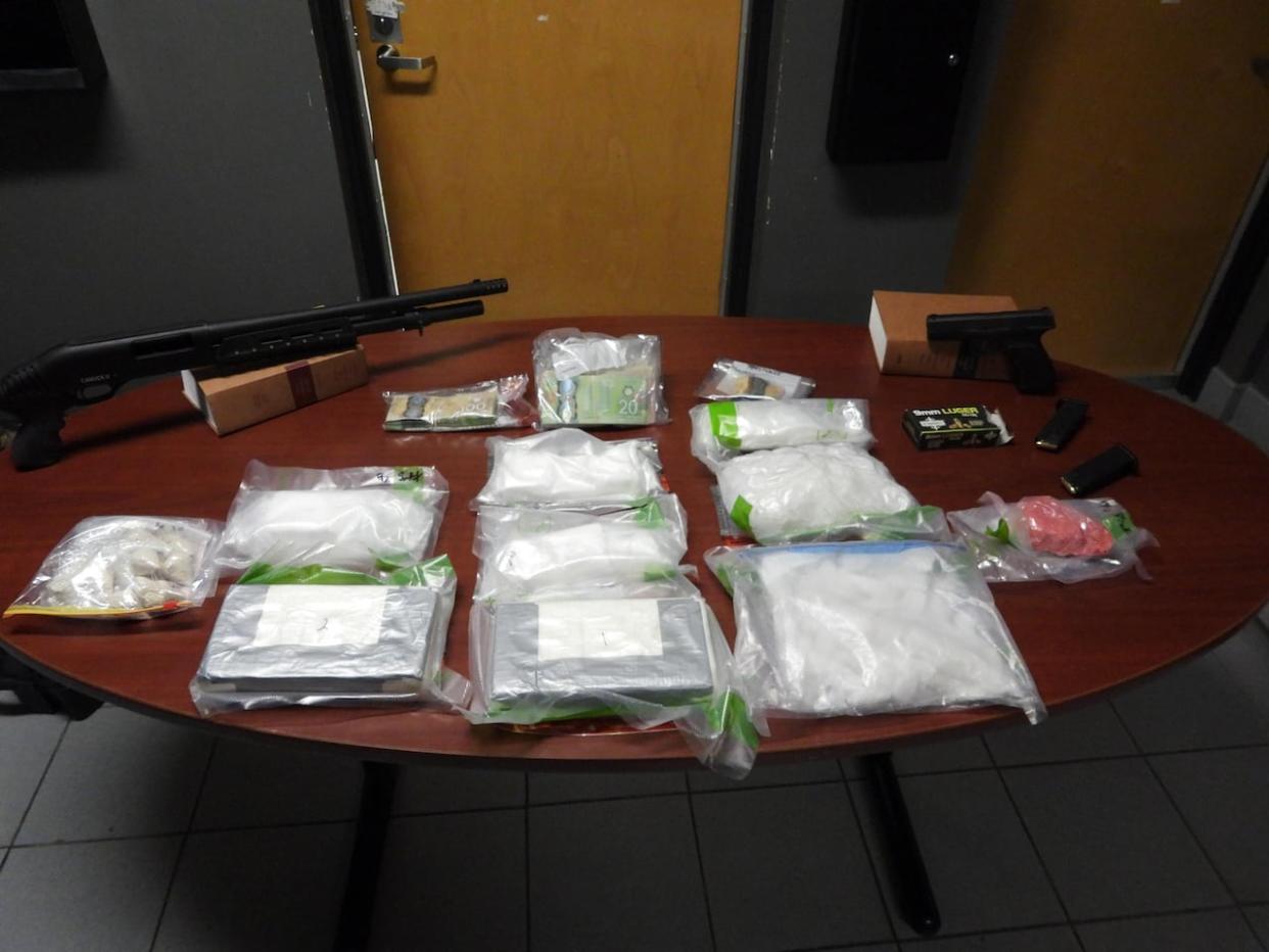 Police in Chatham-Kent said investigators seized about $500,000 in drugs, as well as numerous weapons and quantities of cash, during a drug investigation as a home, car and storage unit in Chatham last week.  (Submitted by Chatham-Kent Police Service - image credit)