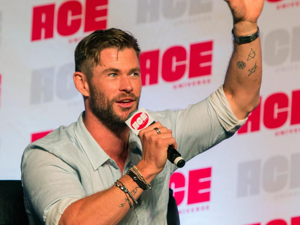 Chris Hemsworth waving while in a chair at ACE Comic Con in October 2019.