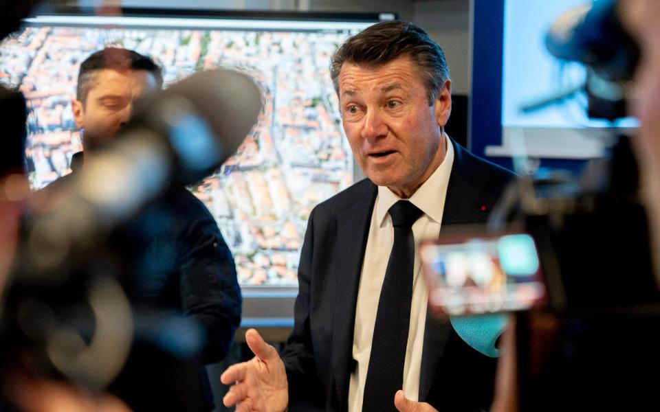 Christian Estrosi, the mayor of Nice, explains his curfew decree to journalists