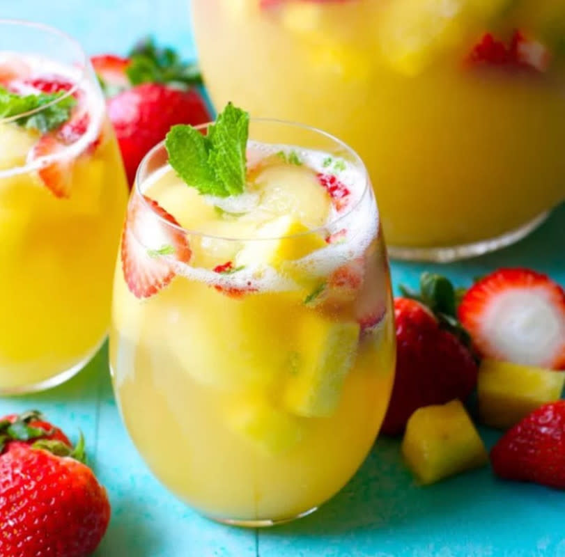 <p>Try this effervescent beverage for your next party! Sweet pineapple juice is paired with bubbly ginger ale, fresh fruit, and mint for a refreshing non-alcoholic punch.</p><p><strong>Get the recipe: <a href="https://www.maebells.com/sparkling-pineapple-strawberry-punch/" rel="nofollow noopener" target="_blank" data-ylk="slk:Sparkling Pineapple Strawberry Punch;elm:context_link;itc:0;sec:content-canvas" class="link rapid-noclick-resp">Sparkling Pineapple Strawberry Punch</a></strong></p>