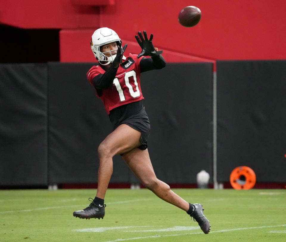 Arizona Cardinals DeAndre Hopkins (10) catches a pass during training camp at State Farm Stadium in Glendale on July 27, 2022.