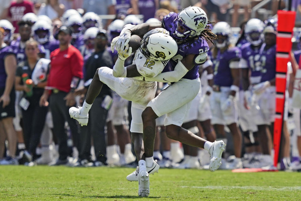 Colorado cornerback Travis Hunter (12) catches a pass for a first down against TCU cornerback Avery Helm (24) during the second half of an NCAA college football game Saturday, Sept. 2, 2023, in Fort Worth, Texas. (AP Photo/LM Otero)