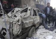 Residents look for survivors at a damaged site after what activists said was an air strike from forces loyal to Syria's President Bashar al-Assad in the Karam Al-Beik area of Aleppo, December 15, 2013. REUTERS/Wasim Al-Halabi