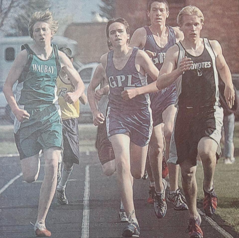 Great Plains Lutheran runners Josh Rawerts (center) and Josh Jakober battle for the lead with Waverly-South Shore's Jake Stricherz and Waubay's Kevin Gaikowski in the boys' 1,600-meter run during the 2005 Eastern Coteau Conference track and field meet at Allen Mitchell Field in Watertown.