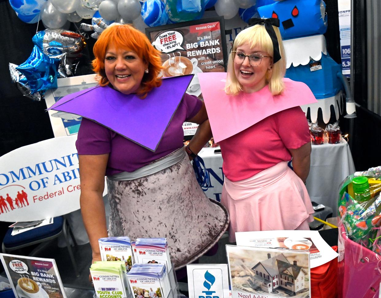 Linda Barfield (left) and Emily Hadley work the Communities of Abilene Federal Credit Union booth during Wednesday’s Business Expo.