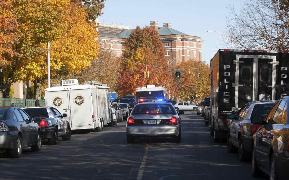 Law enforcement vehicles line the roadway to Central Connecticut State University while it is in lockdown in New Britain, Connecticut November 4, 2013. A person has been taken into custody at Central Connecticut State University on Monday after officials locked down the campus when a suspicious person, possibly armed, was spotted, said New Britain Mayor Tim O'Brien. Citing students, local media said police had searched for a person who appeared to be carrying a gun and what looked like a sword. (REUTERS/Michelle McLoughlin)