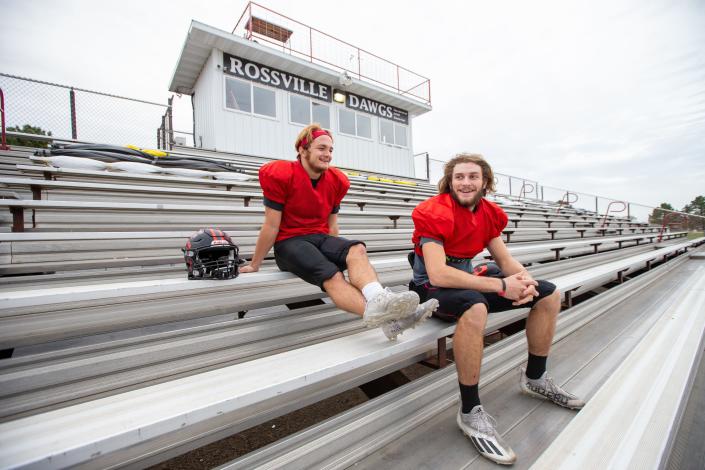 Rossville&#39;s senior quarterback Torrey Horak (right) and senior running back Corey Cantron sit on the stands they played behind growing up as kids attending Rossville football games.