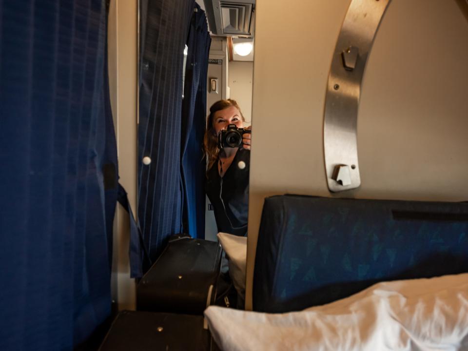 molly allen looking in mirror inside roomette on amtrak