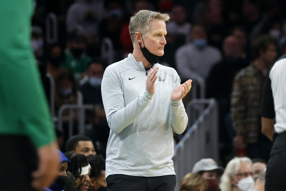 Golden State Warriors head coach Steve Kerr claps for this team during the first half of an NBA basketball game against the Boston Celtics, Friday, Dec. 17, 2021, in Boston. (AP Photo/Mary Schwalm)