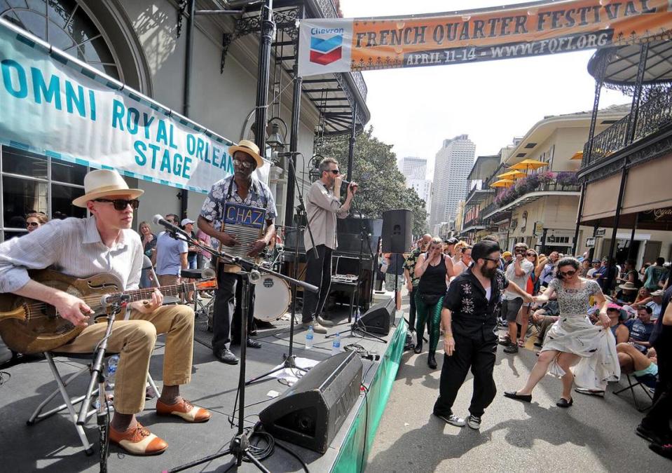 ancers swing to the music of the Washboard Chaz Blues Trio on the Omni Hotel Orleans Stage on Royal Street during the 2019 French Quarter Festival.