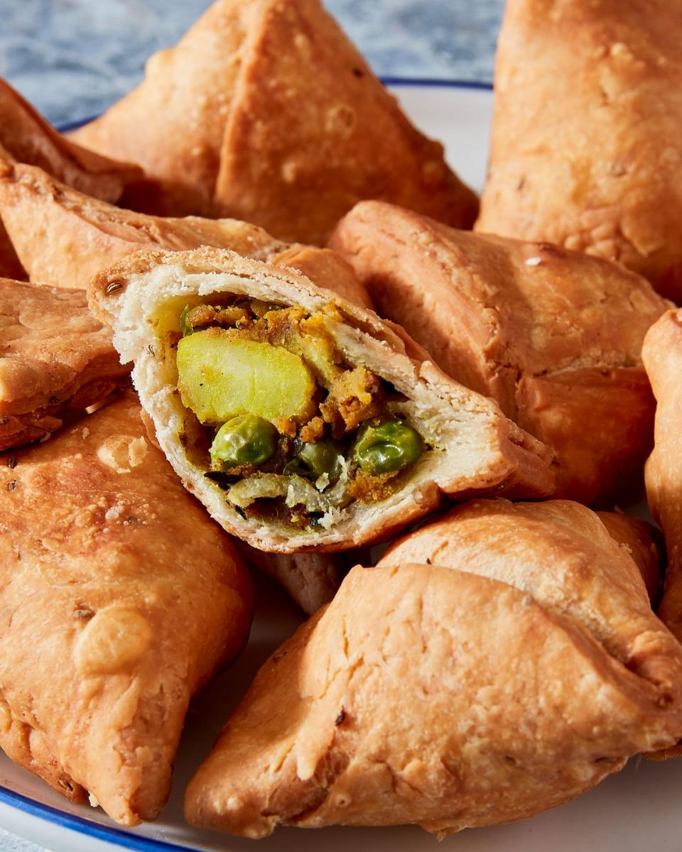 <p>Homemade samosas don't need to be intimidating! The spiced potato filling is fast and easy, and the dough comes together quickly using melted <a href="https://www.delish.com/cooking/a36343397/what-is-ghee/" rel="nofollow noopener" target="_blank" data-ylk="slk:ghee;elm:context_link;itc:0;sec:content-canvas" class="link ">ghee</a>. You may need to hunt down some spices and seeds, but it's well worth it for the best, most authentic-tasting samosas ever. <br><br>Get the <strong><a href="https://www.delish.com/cooking/recipe-ideas/a37224993/samosa-recipe/" rel="nofollow noopener" target="_blank" data-ylk="slk:Homemade Samosas recipe;elm:context_link;itc:0;sec:content-canvas" class="link ">Homemade Samosas recipe</a></strong>. </p>