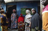 Relatives and friends wait outside a house as the body of 19-year-old Ibrahim Kamau is prepared prior to burial, in Nairobi, Kenya Friday, June 28, 2024. Kamau was shot during a protest on Tuesday against the government proposed tax bill. Protesters stormed parliament on Tuesday and drew police fire in chaos that left several people dead. (AP Photo/Brian Inganga)