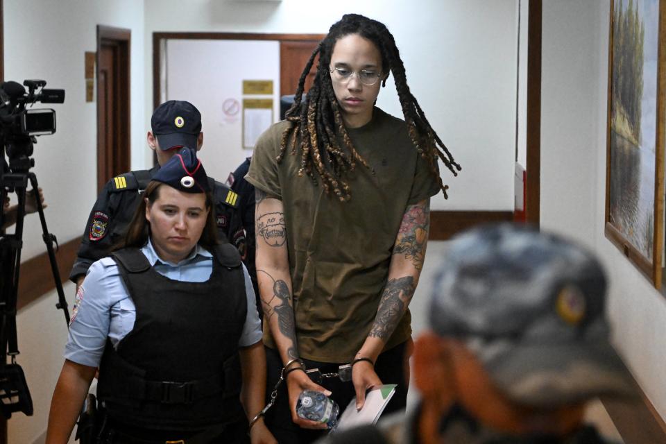 Griner is shown being escorted by police before a hearing during her trial on charges of drug smuggling. (Photo by NATALIA KOLESNIKOVA/AFP via Getty Images)