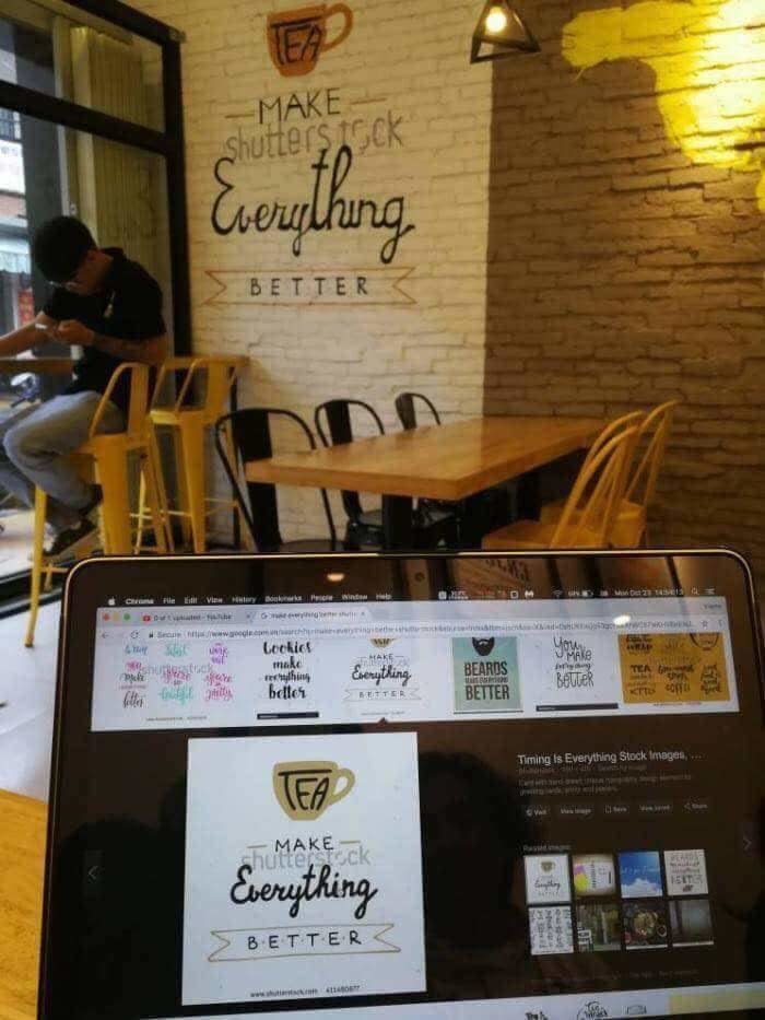 "Make everything better" sign in a café with "Shutterstock" in the background