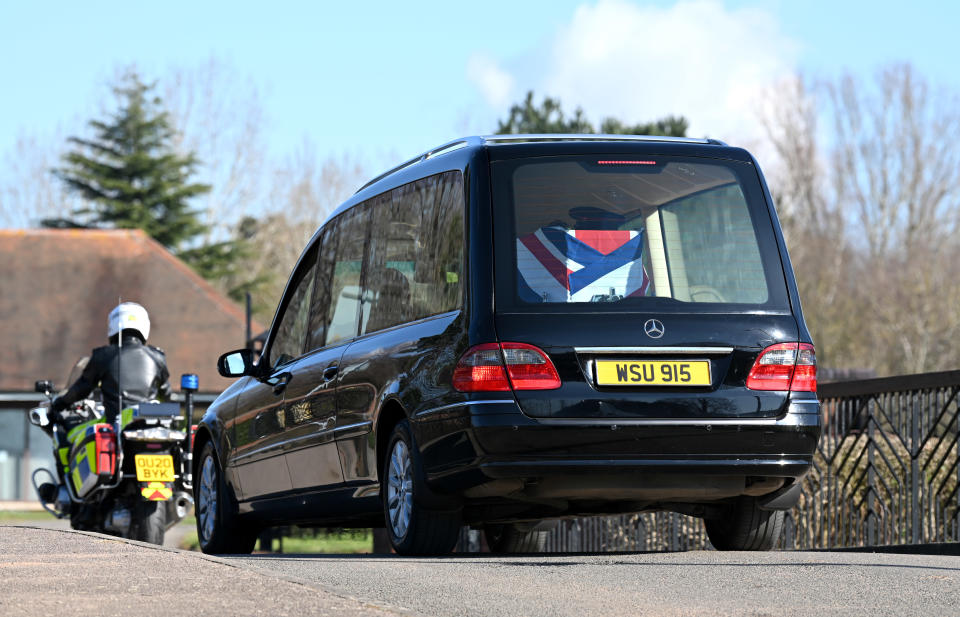 BEDFORD, ENGLAND - FEBRUARY 27: The funeral procession for Captain Sir Tom Moore passes through Bedford on the way to Bedford Crematorium ahead of a private ceremony on February 27, 2021 in Bedford, England. WWII veteran, Sir Tom raised nearly £33 million for NHS charities ahead of his 100th birthday last year by walking laps of his garden in Marston Moretaine, Bedfordshire. He died on the 2nd of February after testing positive for COVID-19. (Photo by Karwai Tang/WireImage)