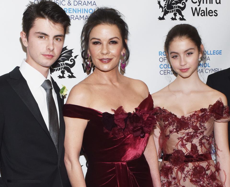 Catherine Zeta-Jones proudly posed alongside her children, son Dylan and daughter Carys, on the red carpet at The Royal Welsh College of Music & Drama 2019 Gala at The Rainbow Room on March 1, 2019 in New York City.