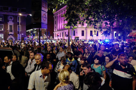 Commuters are seen outside Euston Station after police evacuated the area following a security alert in London, Britain, August 29, 2017. REUTERS/Tolga Akmen