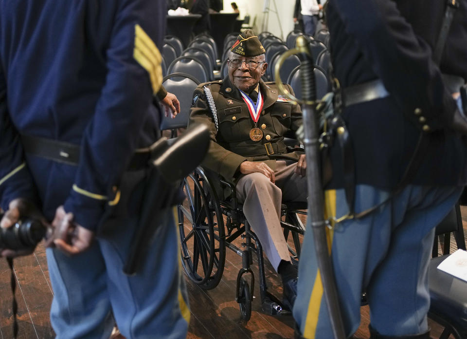 George Ruth Jr., talks to a couple Buffalo Soldiers at the Buffalo Soldiers Museum before a U.S. Army event recognizing the legacy of the soldiers from the 3rd Battalion, 24th Infantry Regiment, at Buffalo Soldiers Museum Monday, Nov. 13, 2023, in Houston. U.S. Army officials say they will overturn the convictions of over 100 Black soldiers accused of a mutiny at a Houston military camp a century ago in a trial that had racial undertones. (Elizabeth Conley/Houston Chronicle via AP)