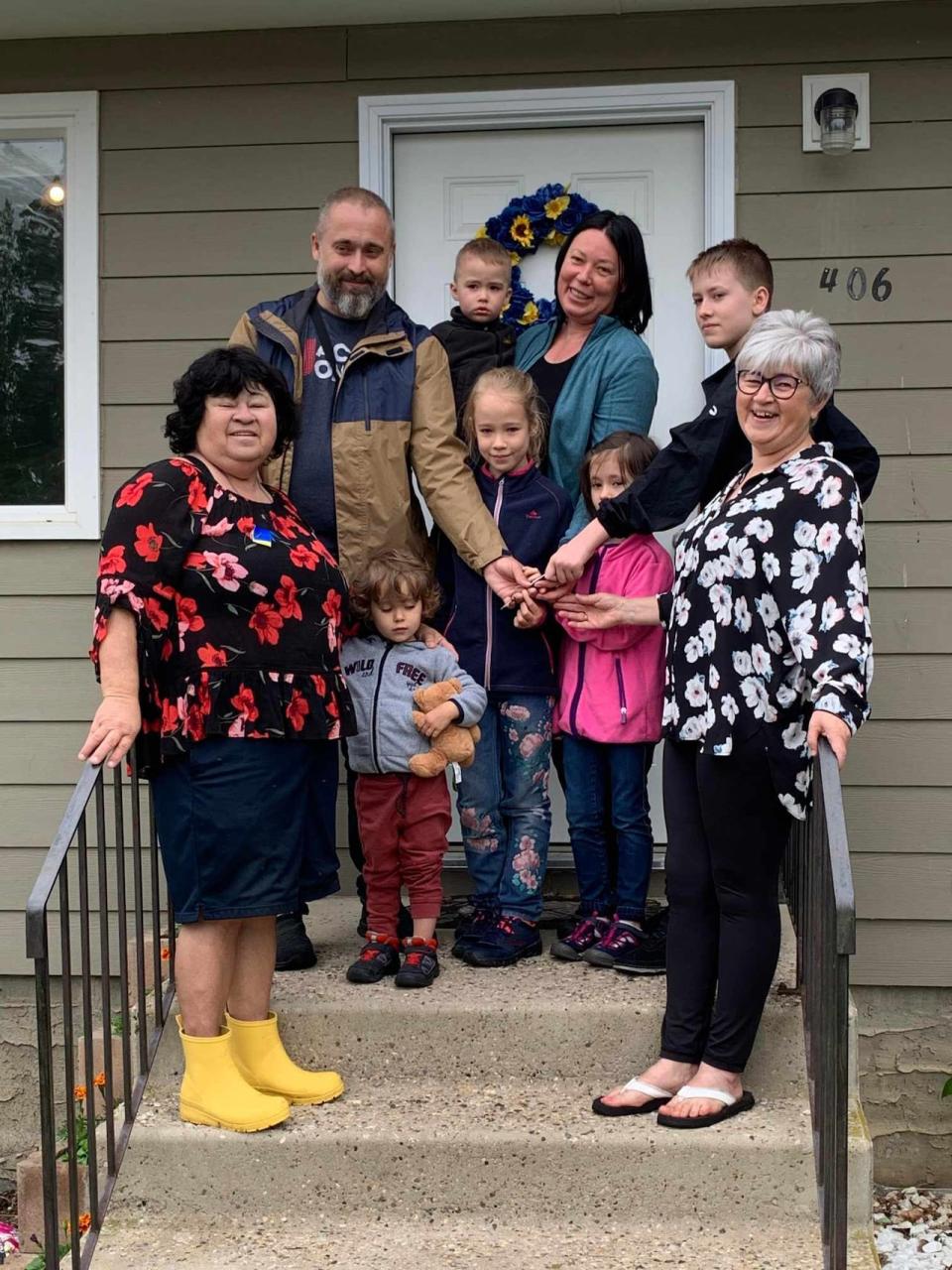 Pavlo and Oksana Malezhyk and five of their children stand in front of their new home in Rosthern in May 2022. Linda Rudachyk is pictured on the far left. 