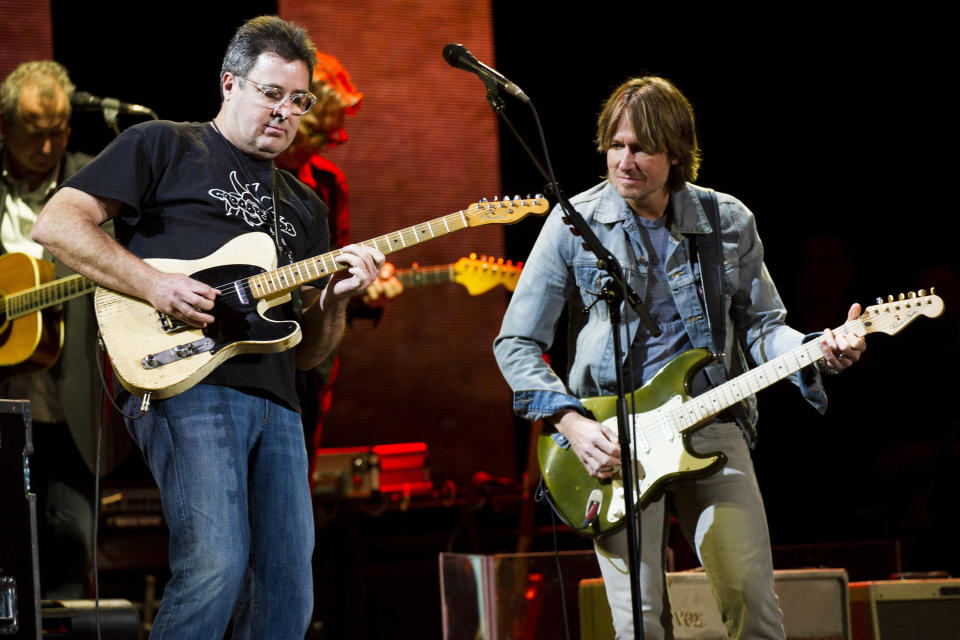 Vince Gill, left, and Keith Urban perform at Eric Clapton's Crossroads Guitar Festival 2013 at Madison Square Garden on Saturday, April 13, 2013, in New York. (Photo by Charles Sykes/Invision/AP)