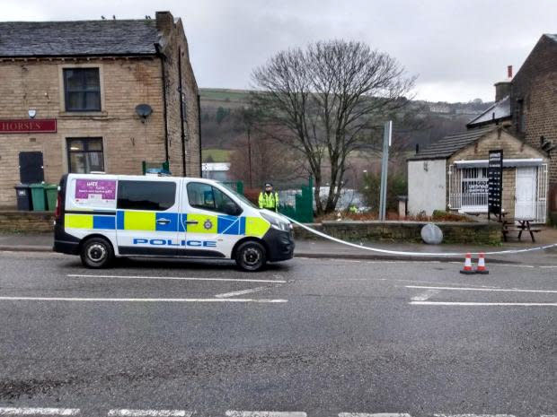 Police on the scene at Manchester Road in Linthwaite, Huddersfield, where a factory worker has died and another man was seriously injured when they were stabbed during a confrontation outside a pharmaceutical plant (Picture: SWNS)