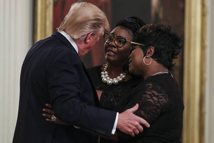 Then-president Donald Trump hugs Diamond and Silk at his social media summit with prominent conservative social media figures on July 11, 2019, in Washington, DC.
