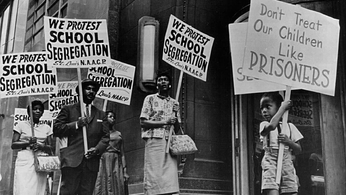 Demonstrators picket in front of a school board office protesting segregation of students. (Photo by National Archive/Newsmakers)
