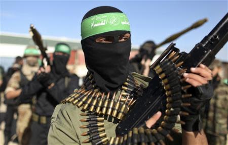 Palestinian members of the al-Qassam brigades, the armed wing of the Hamas movement, stand guard as they wait for the arrival of Hamas chief Khaled Meshaal in Rafah in the southern Gaza Strip in this December 7, 2012 file photograph. REUTERS/Mohammed Salem/Files