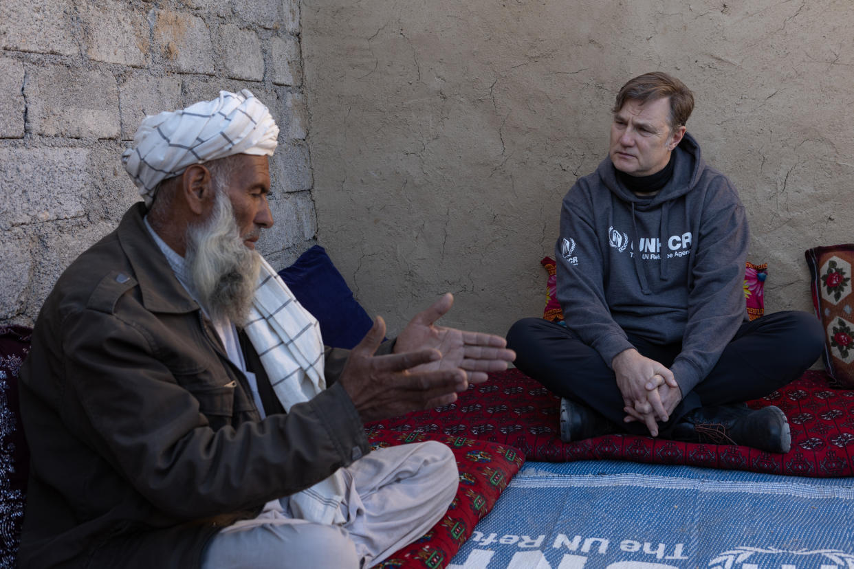 Morrissey speaking to Haji Khan Gul whose home was damaged by the floods in Pakistan earlier this year (UNHCR/Andy Hall/PA)