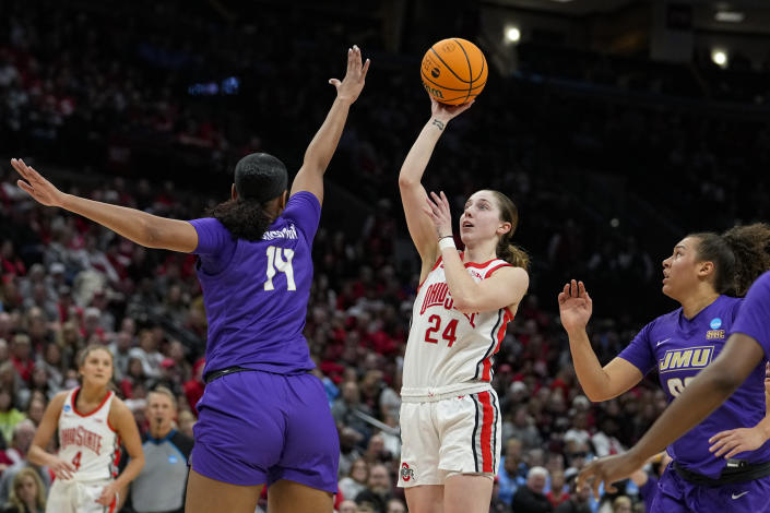 Ohio State guard Taylor Mikesell (24) shoots over James Madison forward Annalicia Goodman (14) in the second half of a first-round college basketball game in the women's NCAA Tournament in Columbus, Ohio, Saturday, March 18, 2023. Ohio State defeated James Madison 80-66. (AP Photo/Michael Conroy)