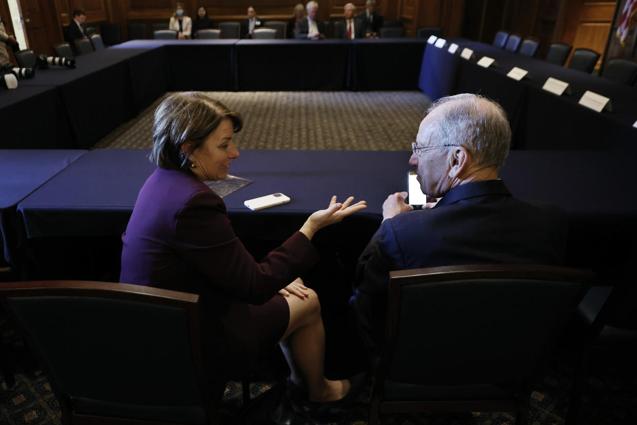 WASHINGTON, DC - JUNE 15: Sen. Amy Klobuchar (D-MN) (L) talks with Sen. Charles Grassley (R-IA) before a meeting between a bipartisan group of senators and member of the Ukrainian parliament in the Mansfield Room at the U.S. Capitol on June 15, 2022 in Washington, DC. The Ukrainians updated their American counterparts about 