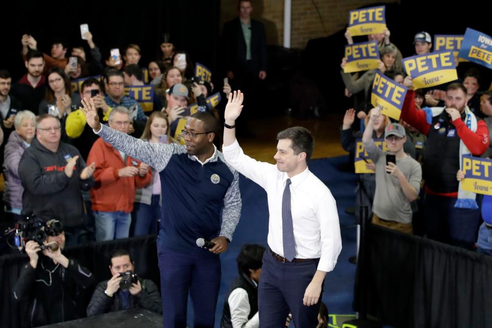 Democratic presidential candidate former South Bend, Ind., Mayor Pete Buttigieg, right, waves to the crowd next to Waterloo, Iowa, Mayor Quentin Hart during a campaign event Saturday, Feb. 1, 2020, in Dubuque, Iowa. (AP Photo/Marcio Jose Sanchez)