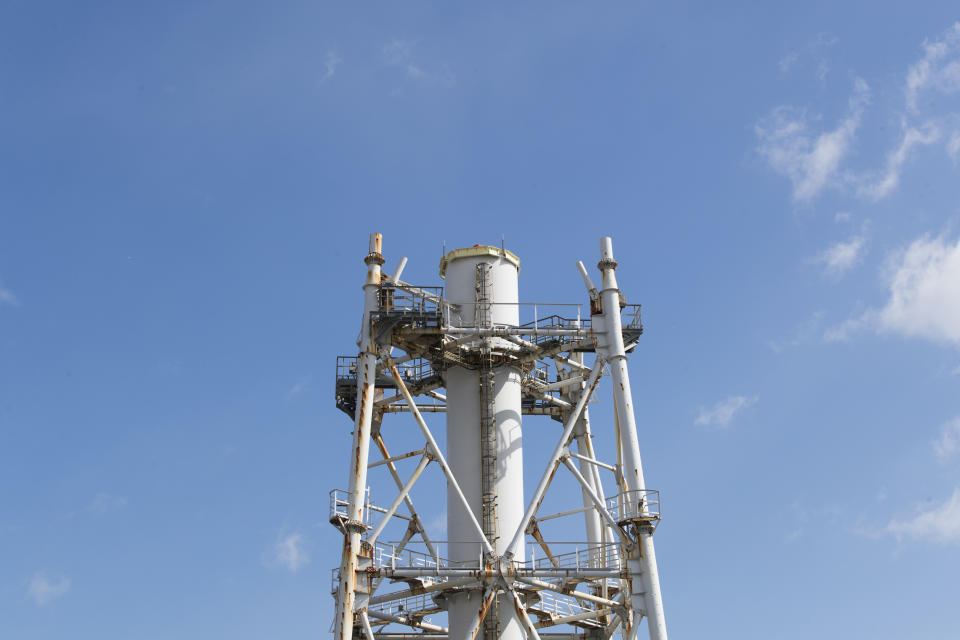 This photo shows the exhaust stack shared with the Unit 1 and 2 reactors at the Fukushima Daiichi nuclear power plant in Okuma town, Fukushima prefecture, northeastern Japan, Saturday, Feb. 27, 2021. The exhaust stack has gotten its upper half cut off due to safety concerns. (AP Photo/Hiro Komae)