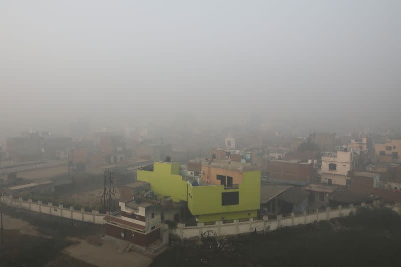 Buildings are seen shrouded in smog in Ghaziabad