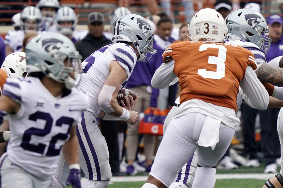 Kansas State quarterback Will Howard (15) runs through the line enroute to a touchdown against Texas during the first half of an NCAA college football game in Austin, Texas, Friday, Nov. 26, 2021. (AP Photo/Chuck Burton)