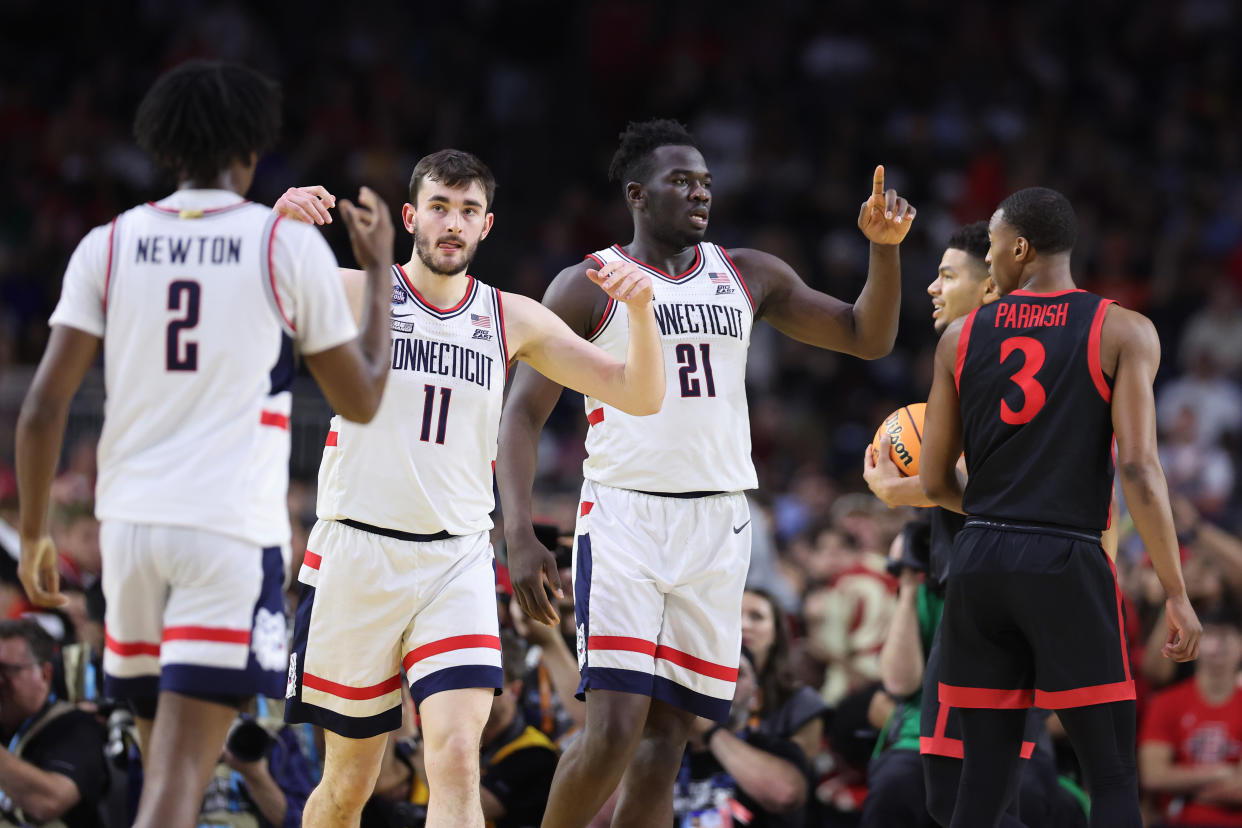 HOUSTON, TEXAS - APRIL 03: Alex Karaban #11 and Adama Sanogo #21 of the Connecticut Huskies react during the first half against the San Diego State Aztecs during the NCAA Men's Basketball Tournament National Championship game at NRG Stadium on April 03, 2023 in Houston, Texas. (Photo by Gregory Shamus/Getty Images)