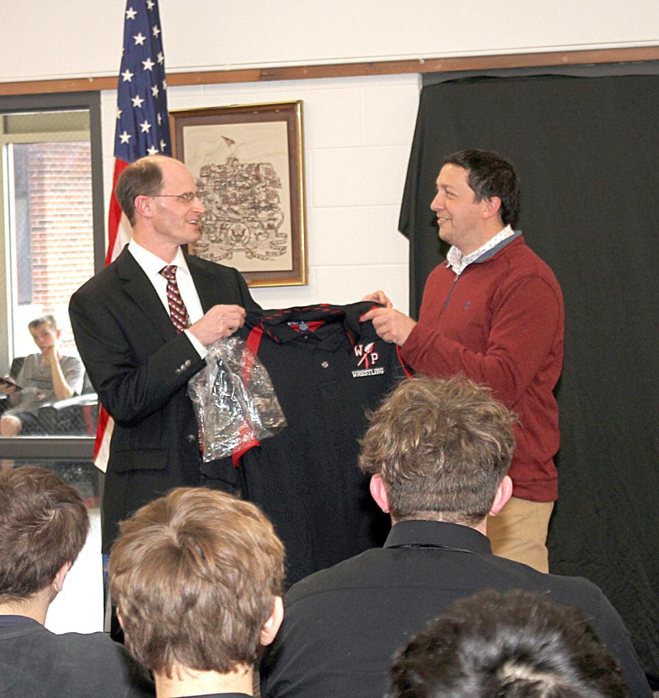 White Pigeon wrestling coach Jay Sosinski presented Michigan State Rep. Steve Carra with a Chiefs wrestling polo on Friday.