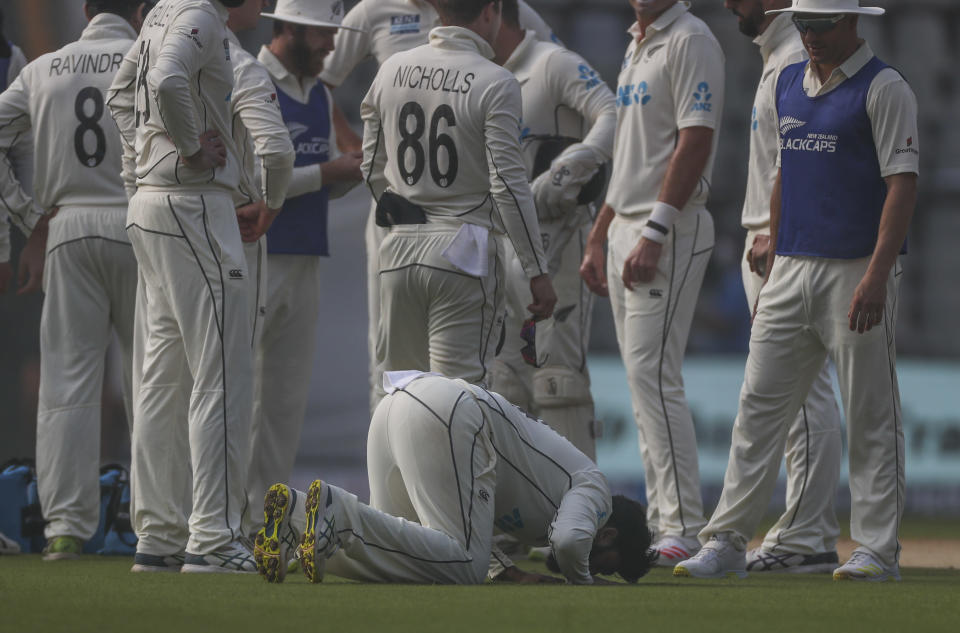 New Zealand's Ajaz Patel bows on the field after taking wicket of India's Ravichandran Ashwin during the day two of their second test cricket match with India in Mumbai, India, Saturday, Dec. 4, 2021.(AP Photo/Rafiq Maqbool)