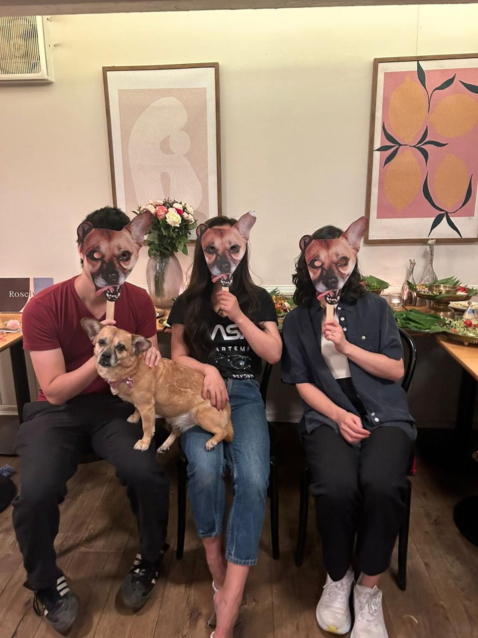 Ms Duan and her friends wearing Artemis photo masks at the pup’s recent birthday party (PA)