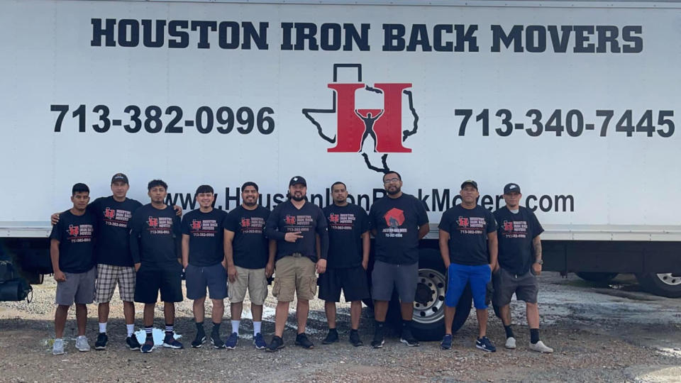 Houston Iron-Back Movers team in front of a company truck