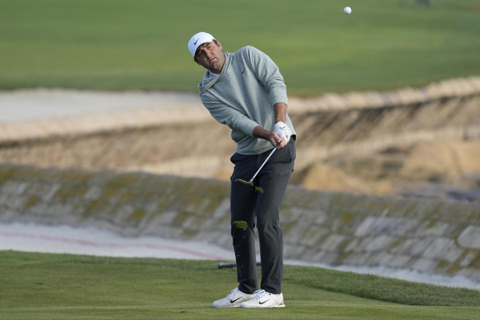 Scottie Scheffler chips to the 18th green at Pebble Beach Golf Links during the second round of the AT&T Pebble Beach National Pro-Am golf tournament in Pebble Beach, Calif., Friday, Feb. 2, 2024. (AP Photo/Eric Risberg)