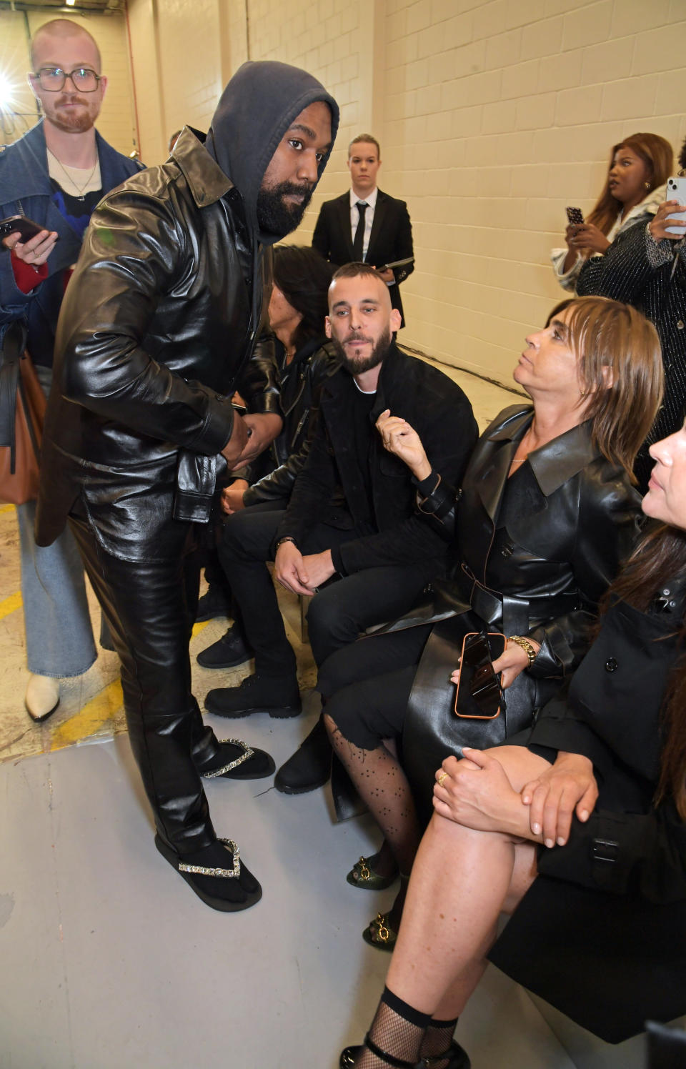 LONDON, ENGLAND - SEPTEMBER 26: (L to R) Kanye West, Vladimir Restoin Roitfeld and Carine Roitfeld attend the Burberry Spring/Summer 2023 runway show in Bermondsey on September 26, 2022 in London, England. (Photo by David M. Benett/Dave Benett/Getty Images for Burberry)