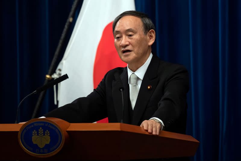 FILE PHOTO: Yoshihide Suga speaks during a news conference following his confirmation as Prime Minister of Japan in Tokyo