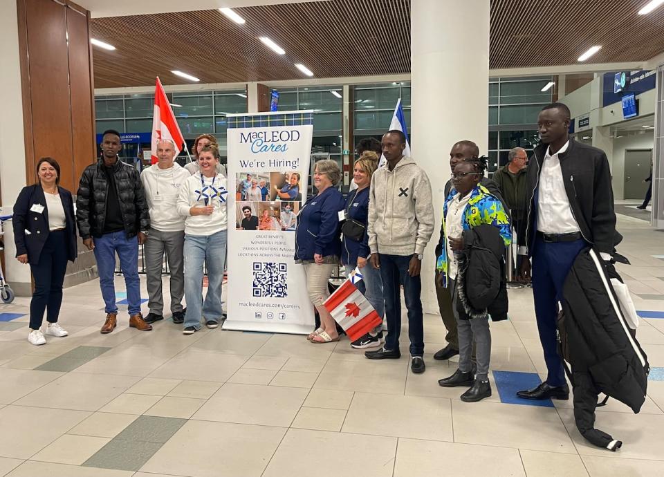 Members of MacLeod Group Health Services welcome five new employees at Halifax Stanfield International Airport Friday night.