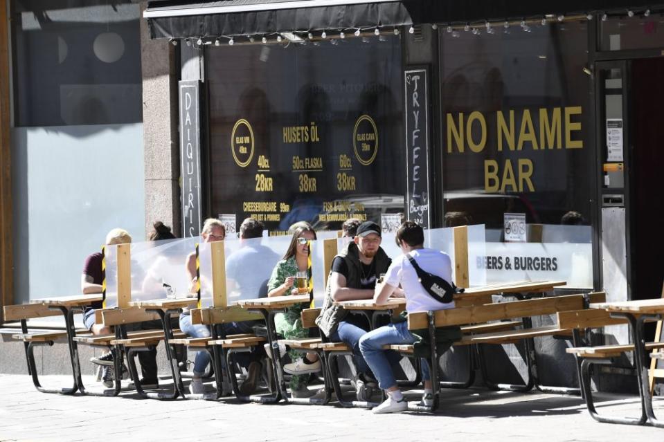 People enjoy the sunny weather at an outdoor restaurant in Stockholm on May 30 amid the novel coronavirus pandemic. Source: AFP