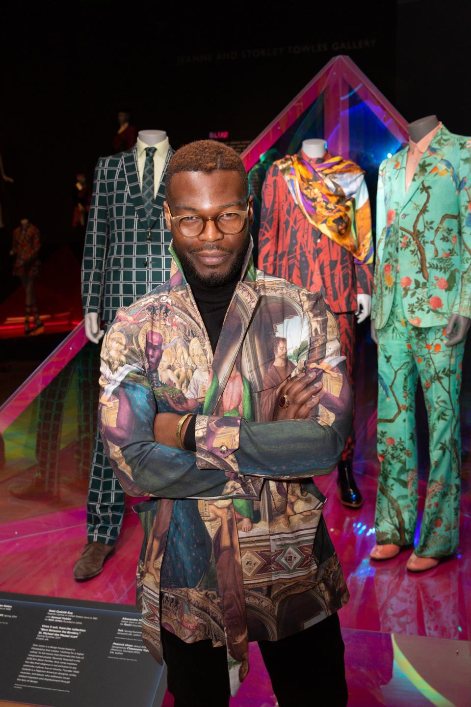 <h1 class="title">Walé Oyéjidé of Ikiré Jones poses in front of his design (middle).</h1><cite class="credit">Photo: Michael Blanchard</cite>