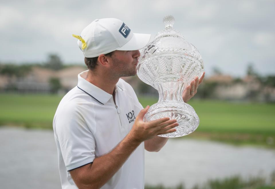 Austin Eckroat kisses trophy after winning he Cognizant Classic in The Palm Beaches at PGA National Resort & Spa on March 4, 2024 in Palm Beach Gardens, Florida.