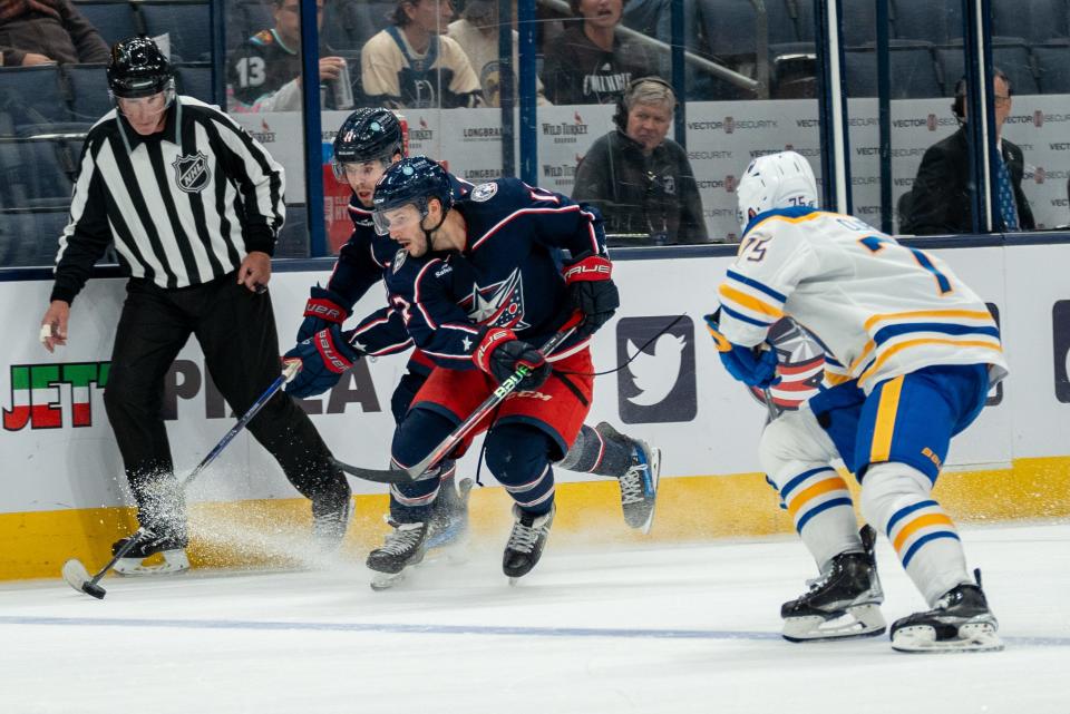 Oct 4, 2023; Columbus, Ohio, United States;
Columbus Blue Jackets forward Justin Danforth (17) and center Adam Fantilli (11) race the puck down the rink against Buffalo Sabres defenseman Connor Clifton (75) during their game on Wednesday, Oct. 4, 2023 at Nationwide Arena.