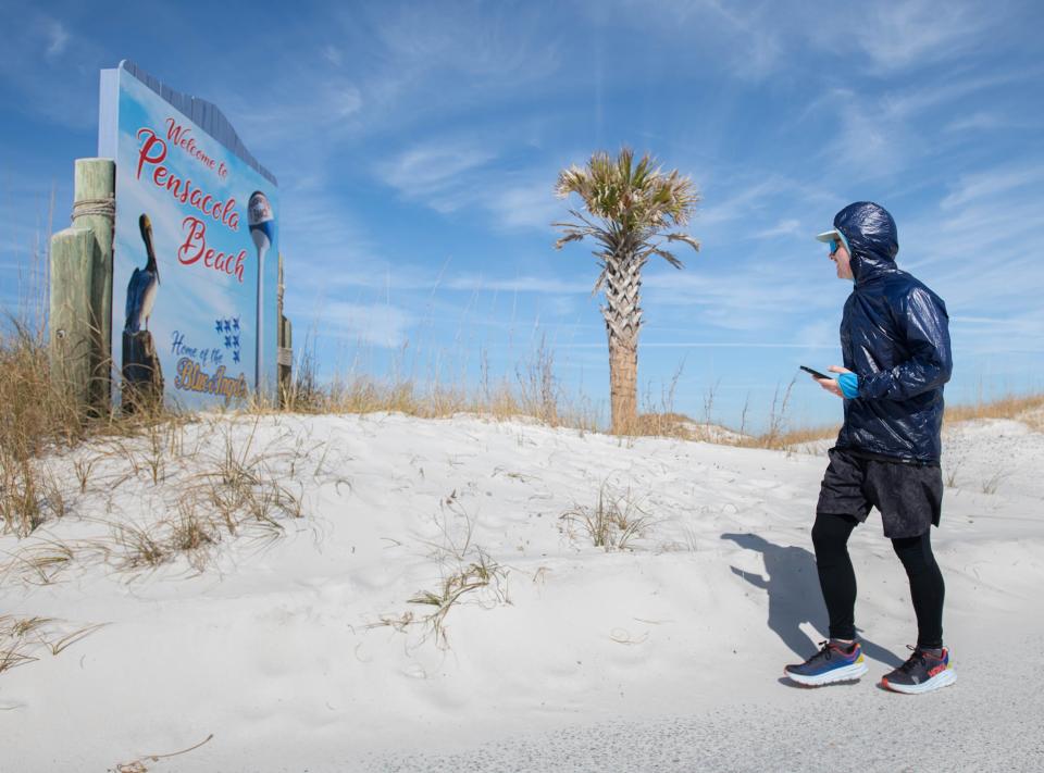 Hunter Leininger walks along Pensacola Beach on Wednesday, Jan. 17, 2024. Leininger finishes his 21 day journey running, walking, and even swimming the entire Florida Trail at Fort Pickens.